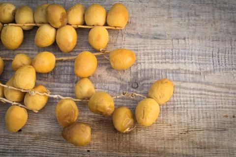 Fresh yellow dates on a sprigs on rustic wooden background. Flat lay 3 Stock Photos