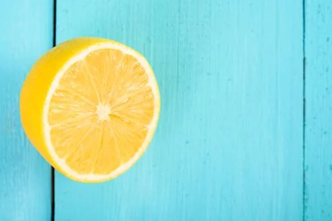 Fresh Yellow Lemon Slice On Turquoise Table Stock Photos