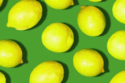 Fresh yellow lemons fruit on green background Stock Footage 287189577
