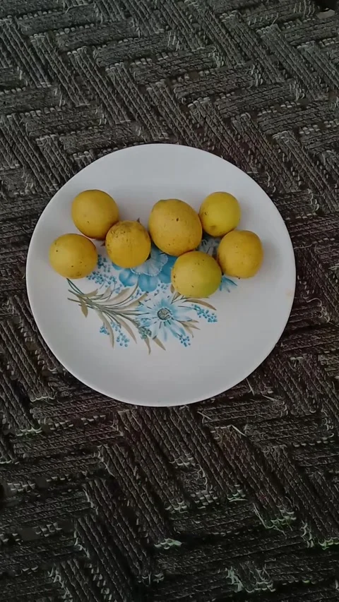 Fresh Yellow Lemons Placed on a White Ceramic Plate. Stock Footage 331899840
