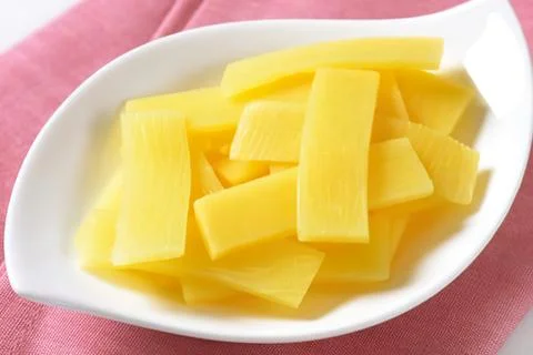 Fresh yellow pineapple chunks on a plate Stock Photos
