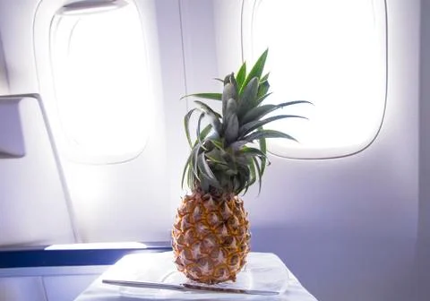 Fresh yellow pineapple on the table in the plane Stock Photos