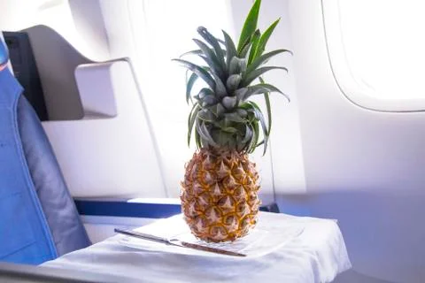 Fresh yellow pineapple on the table in the plane Stock Photos