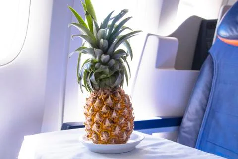 Fresh yellow pineapple on the table in the plane Stock Photos