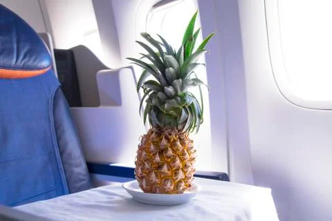 Fresh yellow pineapple on the table in the plane Stock Photos