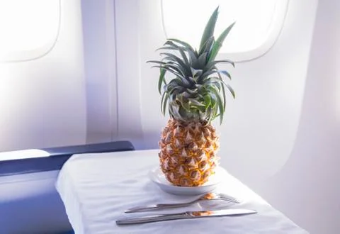 Fresh yellow pineapple on the table in the plane Foto stock