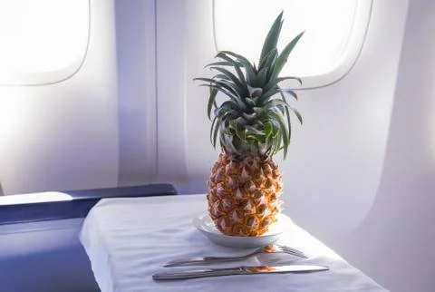 Fresh yellow pineapple on the table in the plane Stock Photos