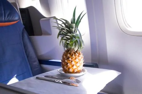 Fresh yellow pineapple on the table in the plane Stock Photos