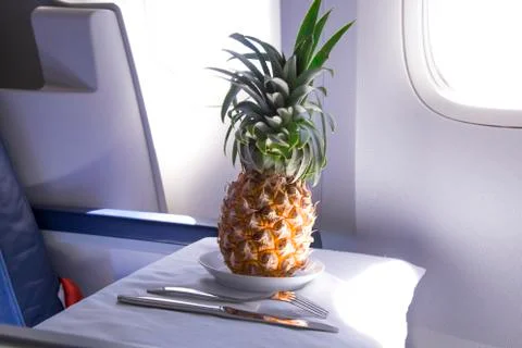 Fresh yellow pineapple on the table in the plane Stock Photos