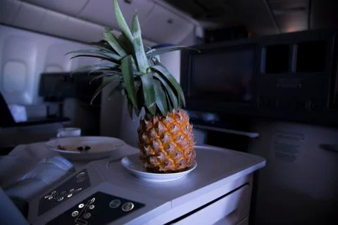 Fresh yellow pineapple on the table in the plane Stock Photos