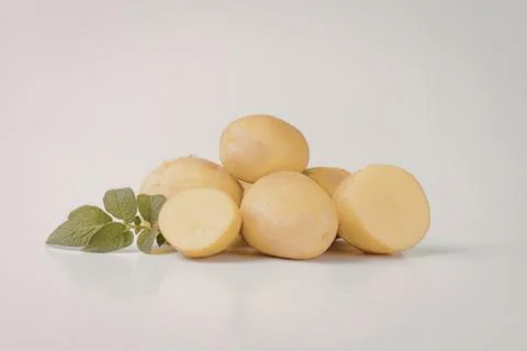 Fresh yellow potatoes with mint leaf Stock Photos