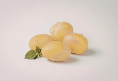 Fresh yellow potatoes with mint leaf Stock Photos