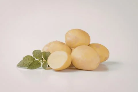 Fresh yellow potatoes with mint leaf Stock Photos
