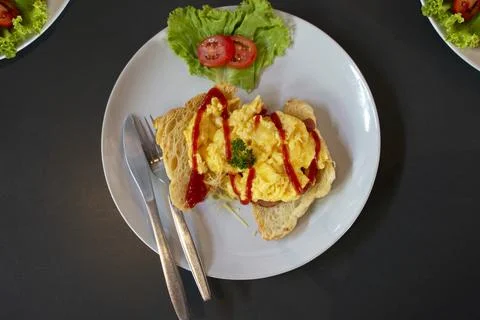 Fresh yellow scrambled egg on bread Stock Photos
