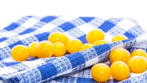 Fresh yellow tomatoes in on blue table mat Foto stock