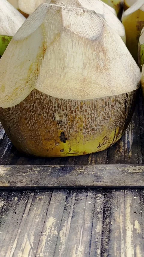 Fresh young coconuts arranged on rustic wooden table Stock Footage 346741800