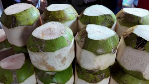 Fresh Young Green Coconuts Prepared for Drinking at Tropical Market Stall Stock Footage 337227429