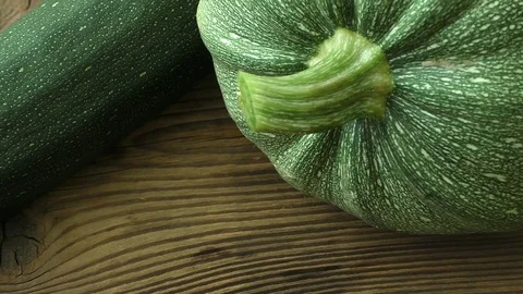 Fresh zucchini on a natural brown wooden background Stock Footage