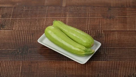 Fresh zucchini on plate Stock Footage 183563864