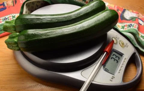 Fresh zucchini on the scale Stock Photos
