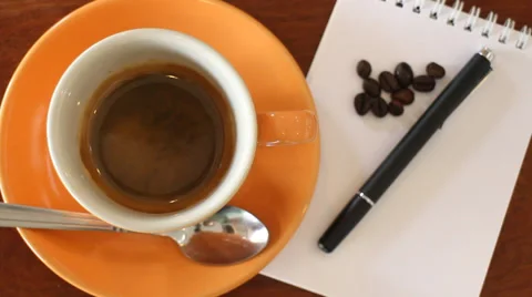 FreshCupOfEspressoWithNotepaperOnTheTable HD Stock Footage 39687972