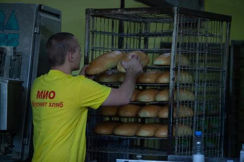 Freshly backed bread ready to be packed Stock Photos