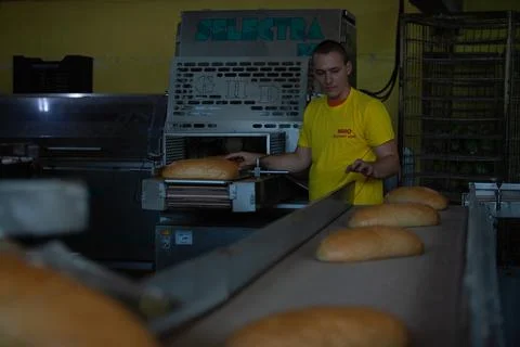 Freshly backed bread ready to be packed Stock Photos