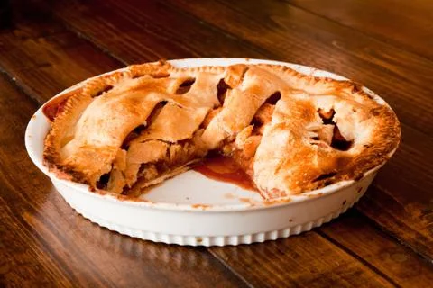 Freshly baked apple pie with a missing portion Stock Photos