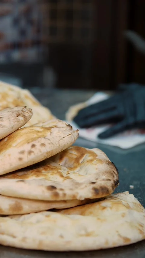 Freshly baked Arabic bread for delicious kebab. Custom-made flatbreads in the Stock Footage 314565190