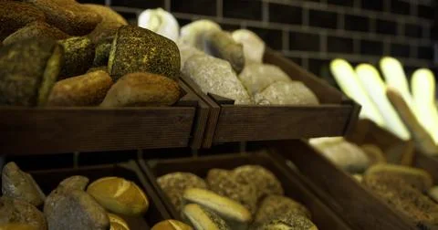 Freshly baked artisan bread displayed in a rustic bakery setting Stock Illustration