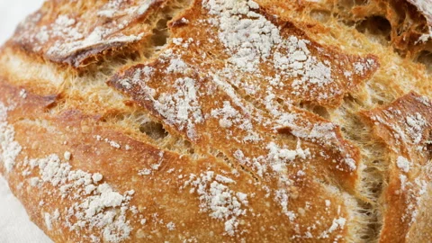 Freshly baked artisan sourdough bread spinning on a kitchen towel. Stock Footage 341497486