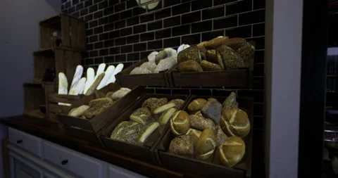 Freshly baked artisanal bread displayed in wooden crates in a bakery Stock Footage 319818568