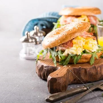 Freshly baked bagel filled with scrambled eggs Stock Photos