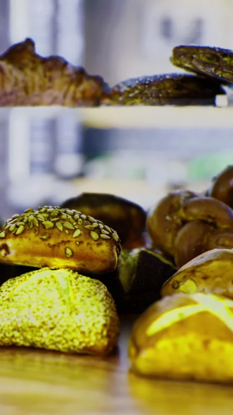 Freshly baked bread and pastries on display at a bakery in the morning Stock Footage 336183285
