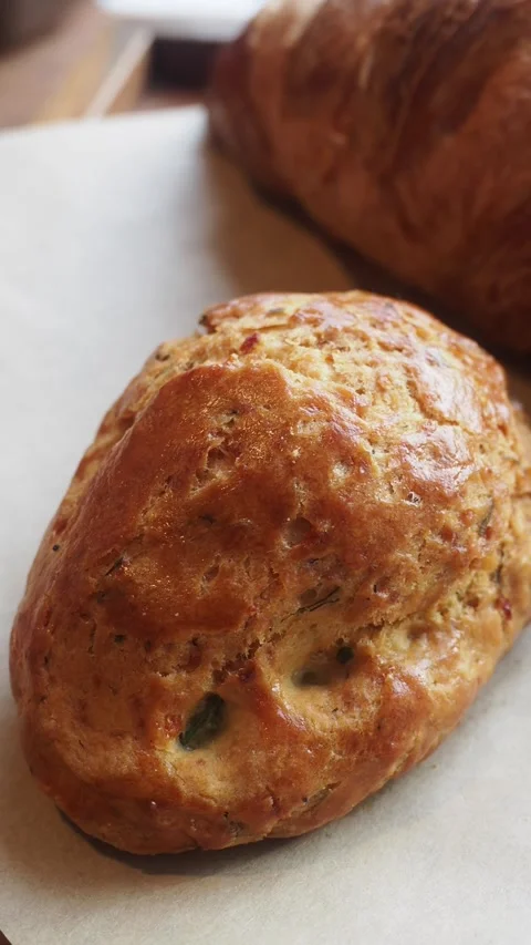 Freshly baked bread and scone on a baking sheet Видео 337284664