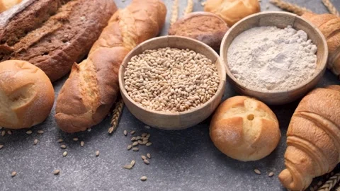 Freshly baked bread assortment and wheat grains Stock Footage 336258132