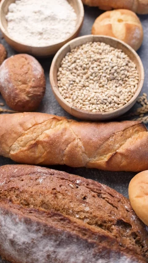 Freshly baked bread assortment and wheat grains Stock Footage 336307966