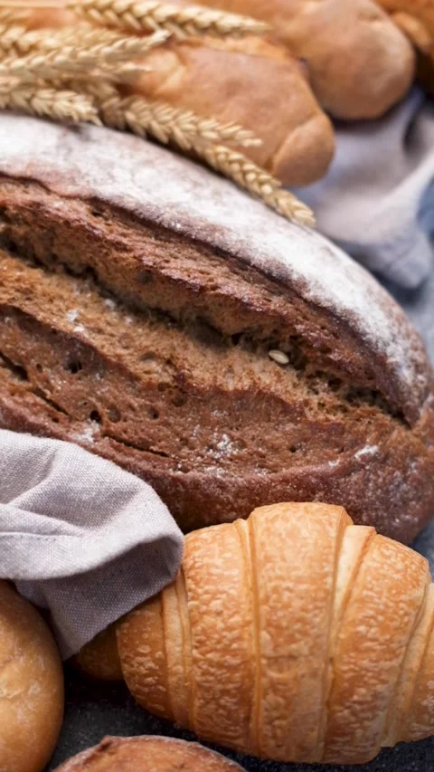 Freshly baked bread assortment and wheat ears Stock Footage 336550055