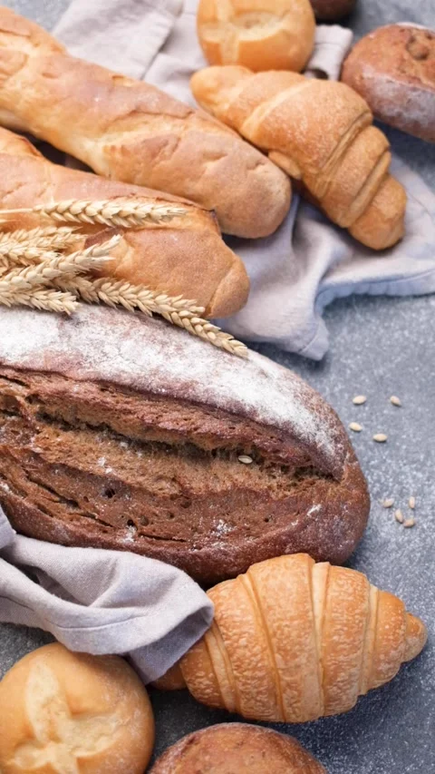 Freshly baked bread assortment and wheat ears Stock Footage 336619790