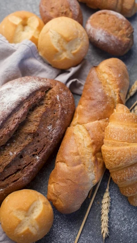 Freshly baked bread assortment on a concrete table Stock Footage 335686705