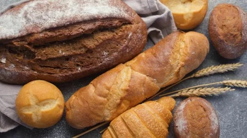Freshly baked bread assortment on a concrete table Stock Footage 335872394