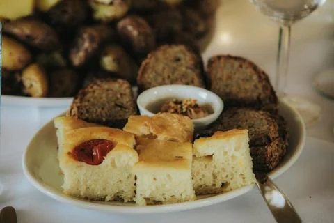Freshly baked bread assortment featuring focaccia with tomatoes, whole grai.. Stock Photos