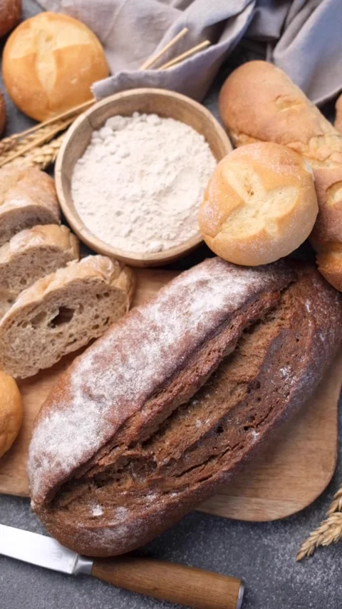 Freshly baked bread assortment with flour and wheat Stock Footage 336550145