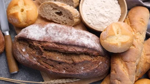 Freshly baked bread assortment with flour and wheat Stock Footage 336619854
