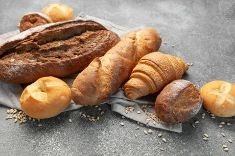 Freshly baked bread assortment on rustic grey background Stock Photos