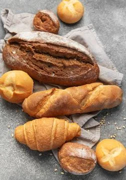 Freshly baked bread assortment on rustic grey background Stock Photos