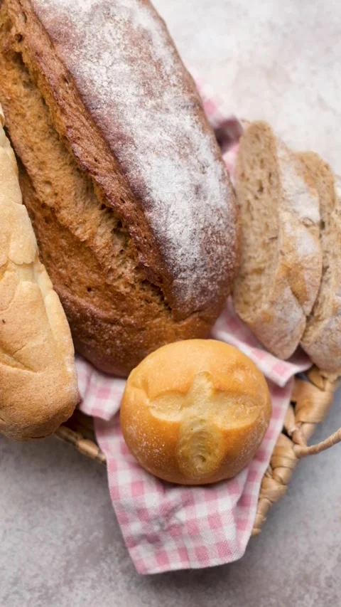 Freshly baked bread assortment in wicker basket Stock Footage 336257956