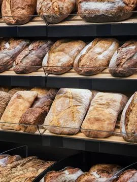 Freshly baked bread on display in a bakery shop during the morning hours fo.. Stock Photos
