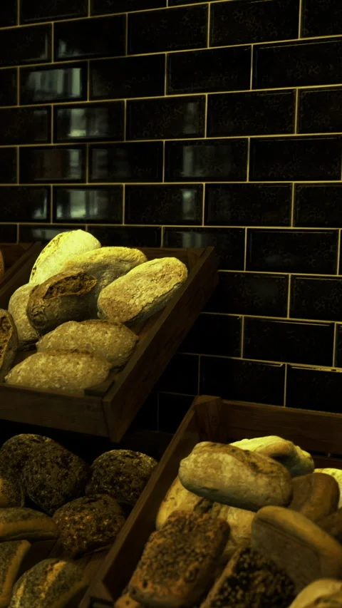 Freshly baked bread displayed in rustic wooden crates at a cozy bakery Stock Footage 331691223