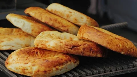 Freshly baked bread lies in a stack, showing off its golden-brown crust Stock Footage 344631777